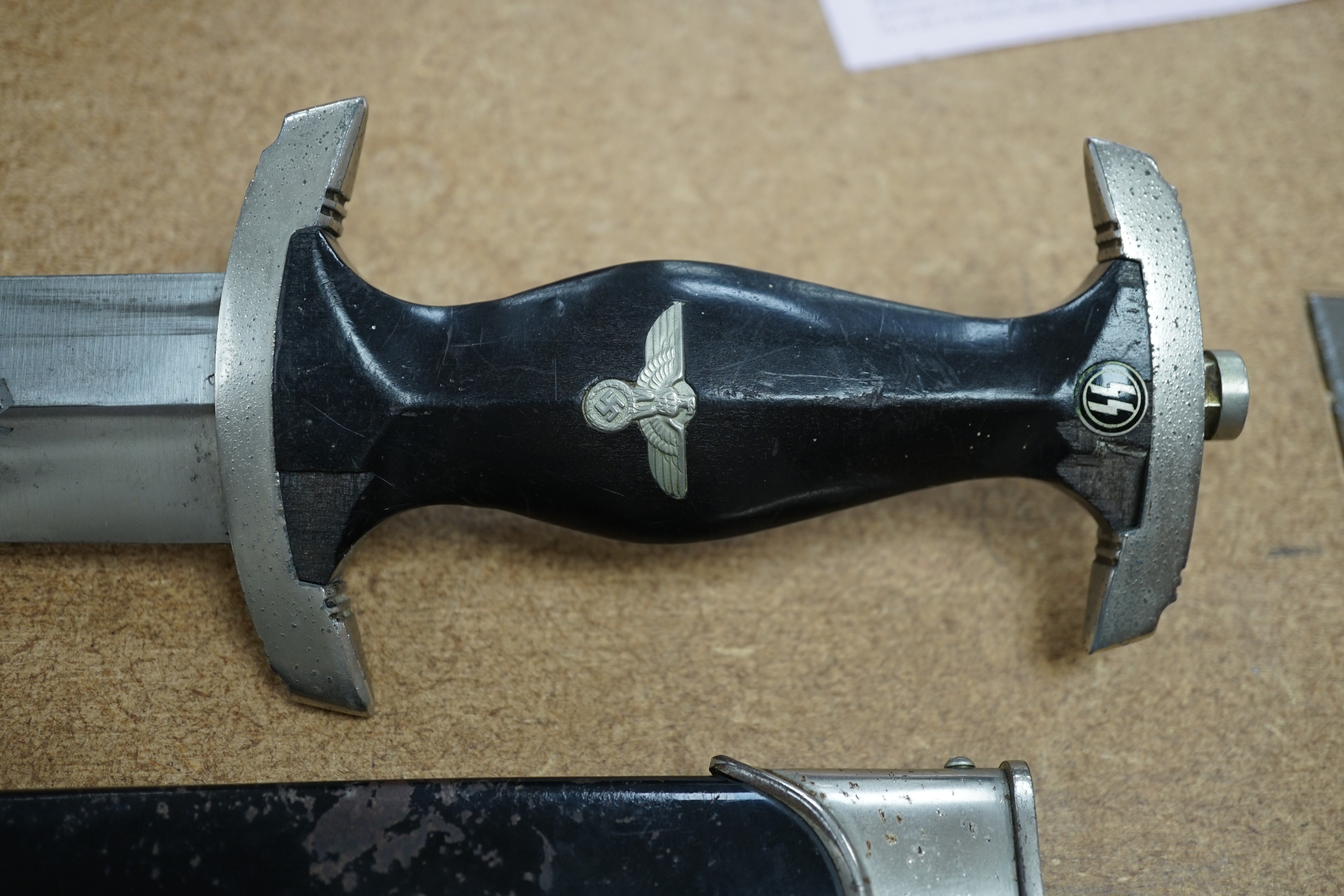 A Third Reich SS dagger, German steel helmet and a Nazi flag